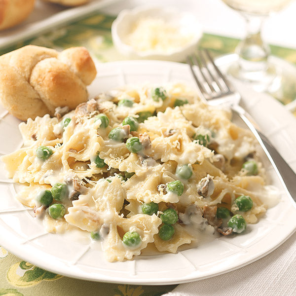 Creamy Bowtie Pasta with durum wheat farfalle combined with prosciutto, peas, and cremini mushrooms in a light cream sauce