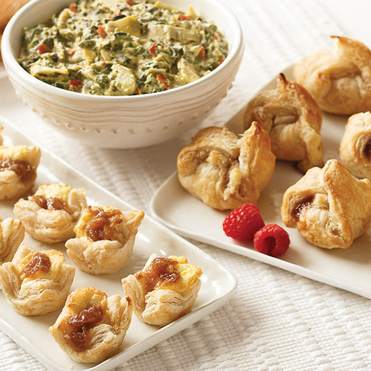 Entertaining Appetizer Sampler, featuring Creamy Spinach & Artichoke Dip, Caramelized Onion & Feta Pastry Blossoms, and Brie & Raspberry en Croûte.
