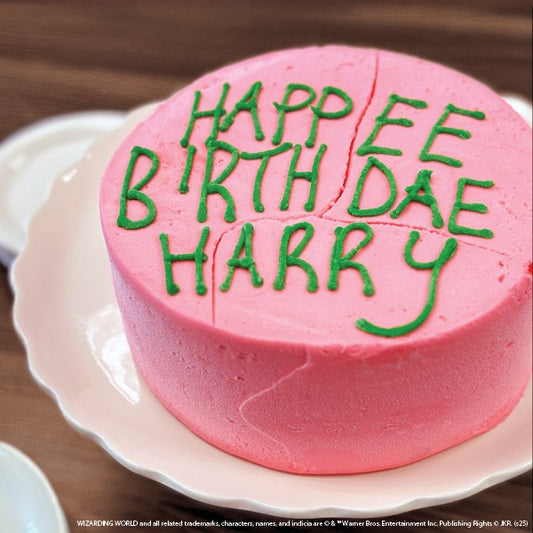Harry Potter™ Birthday Cake - two layer chocolate cake with hand-frosted pink buttercream icing and green hand-drawn lettering, "Happee Birthdae Harry"