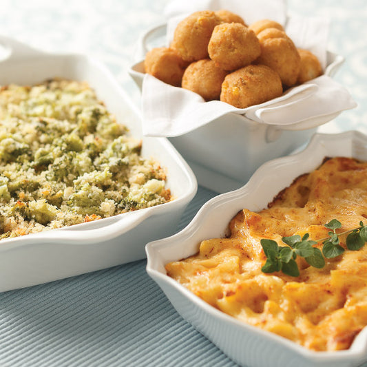 Best Selling Sides Sampler, featuring Broccoli Parmesan Gratin, Sweet Corn Hush Puppies, and Macaroni & Cheese Casserole (from left to right)