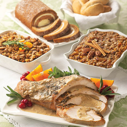 Turkey Breast with Gravy Complete Dinner, featuring Turkey Breast with Gravy, Traditional Herbed Stuffing, Sweet Potato Casserole, Gourmet Dinner Rolls, and Pumpkin Swirl Cake.